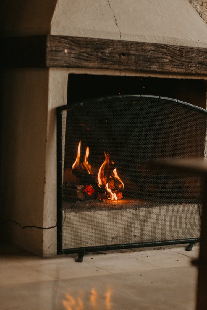 Warm and inviting fireplace with glowing logs, perfect for a cozy home atmosphere.