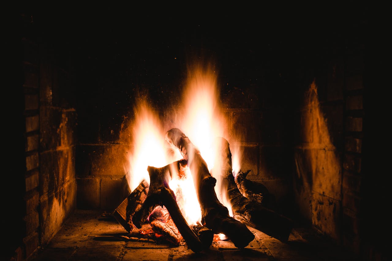 Warm and inviting fireplace with burning logs providing a comforting ambiance.
