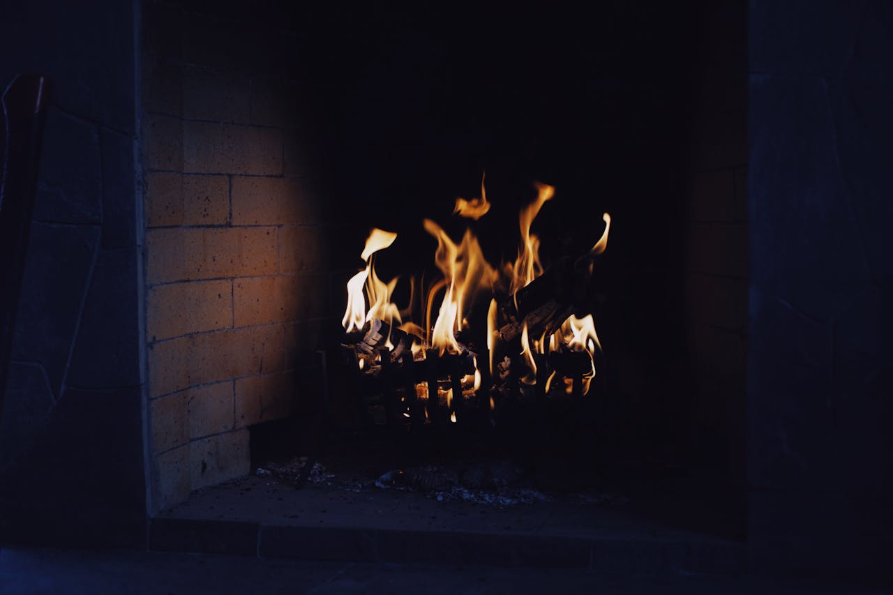 A close-up of a warm, inviting fireplace with flickering flames, perfect for a cozy interior setting.